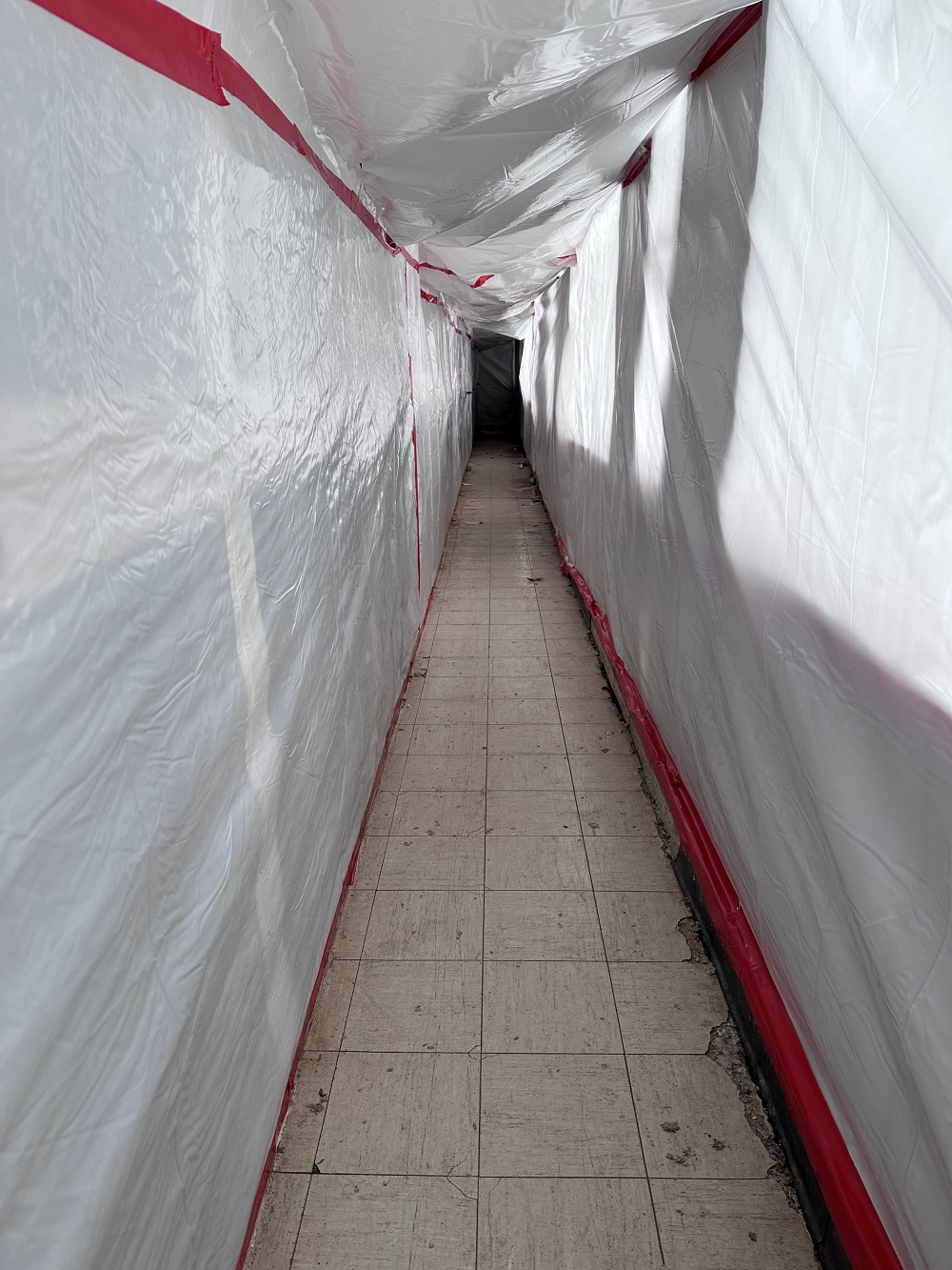 Hallway wrapped in plastic for abatement