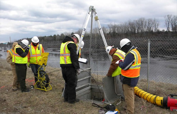 Environmental consultants examining pipe work