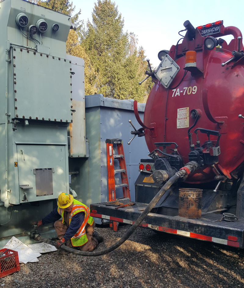 Worker emptying fuel truck 
