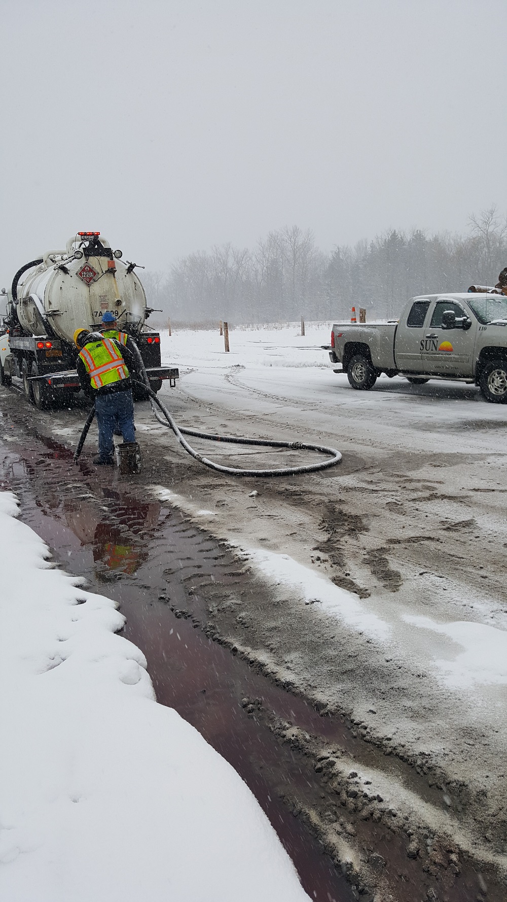 Workers repairing leaking gas truck