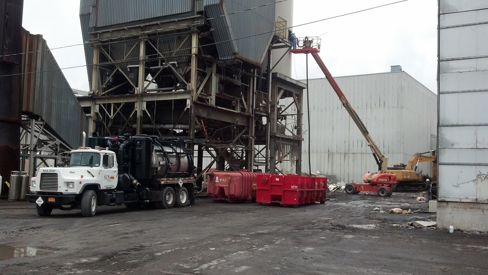Industrial maintenance with trucks at silo