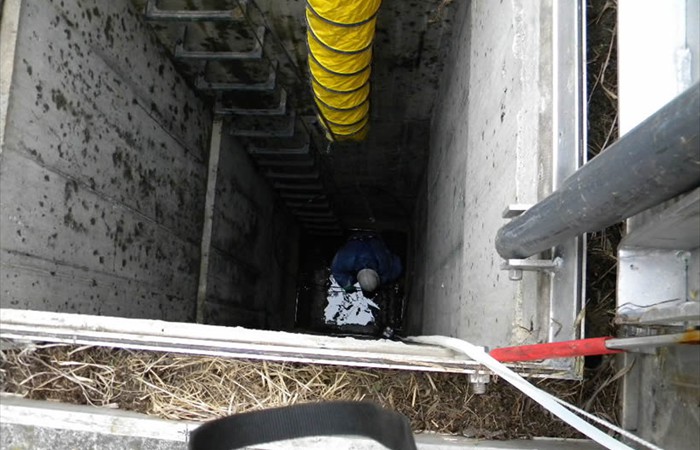 Worker cleaning industrial pit