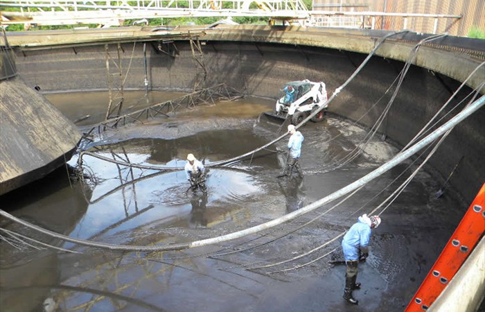 Crew members cleaning tanks