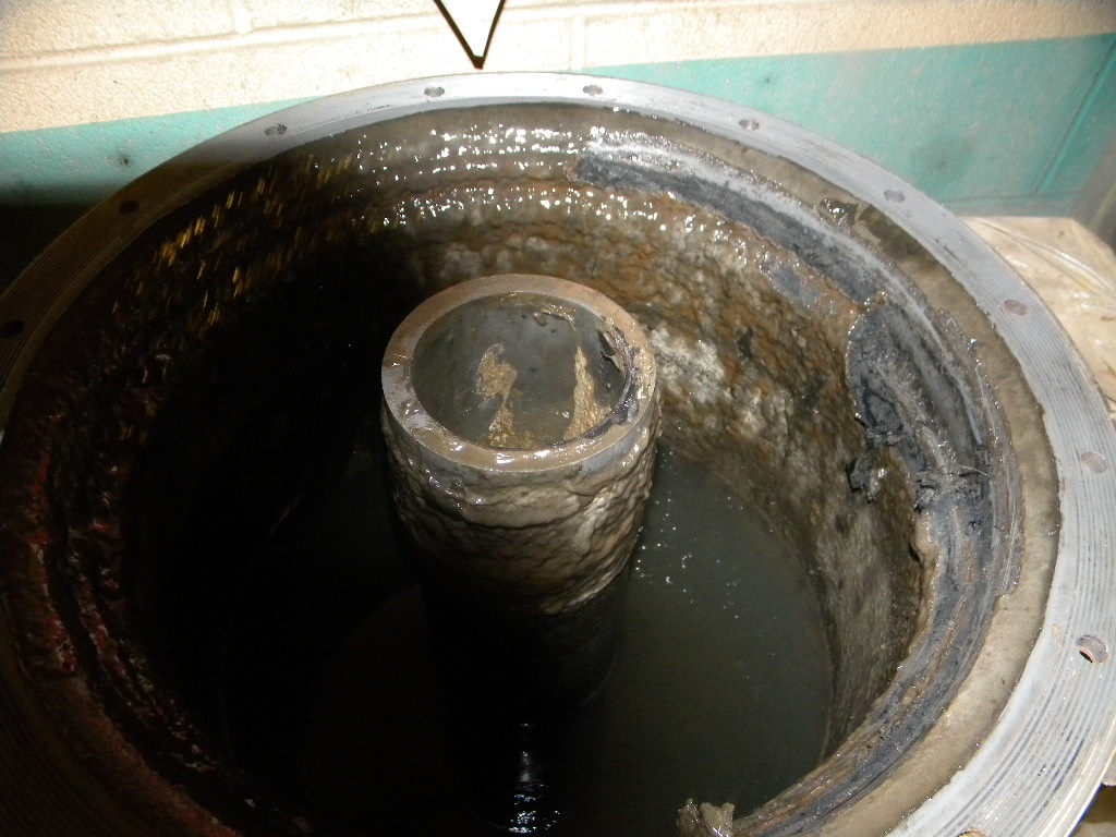 Oil-water separator tank full of sludge