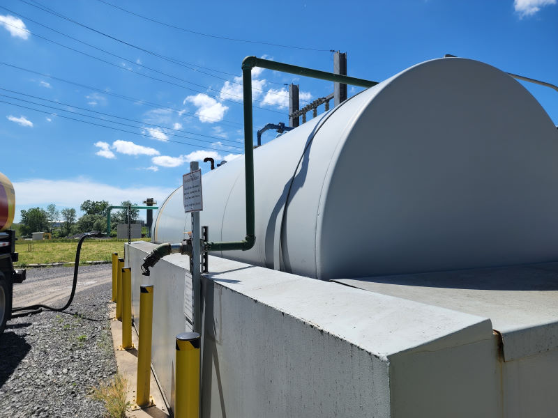 Freshly painted fuel storage tank displaying required warnings