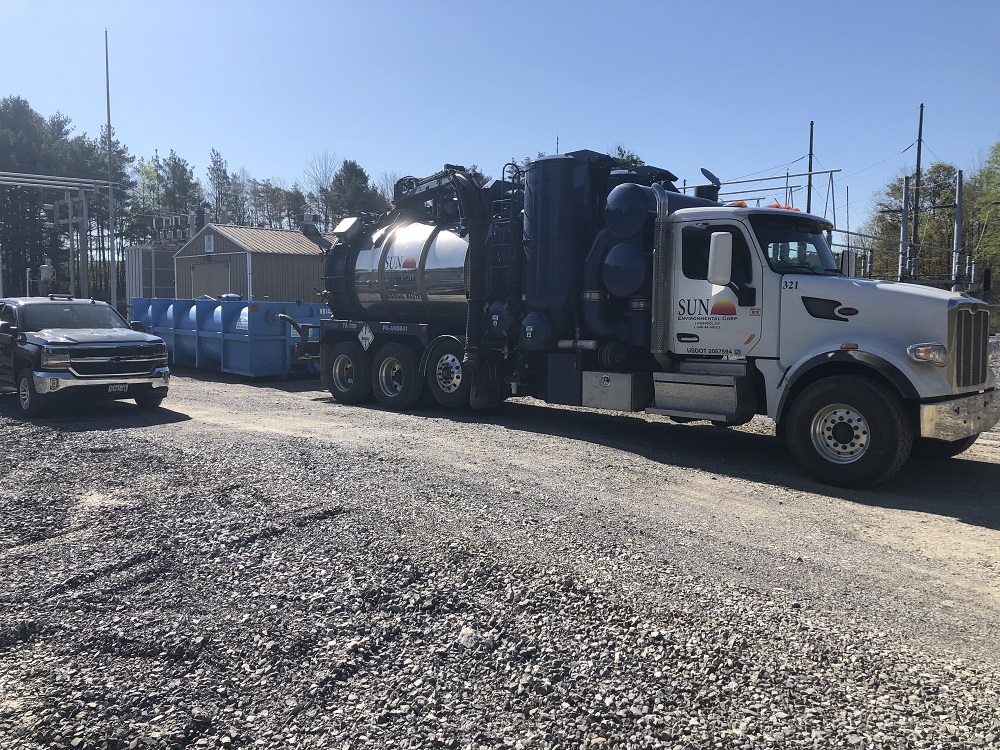 Vacuum truck being used to clean industrial site