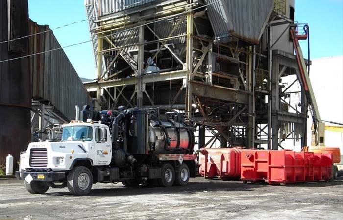 Vacuum truck being used to empty storage boxes